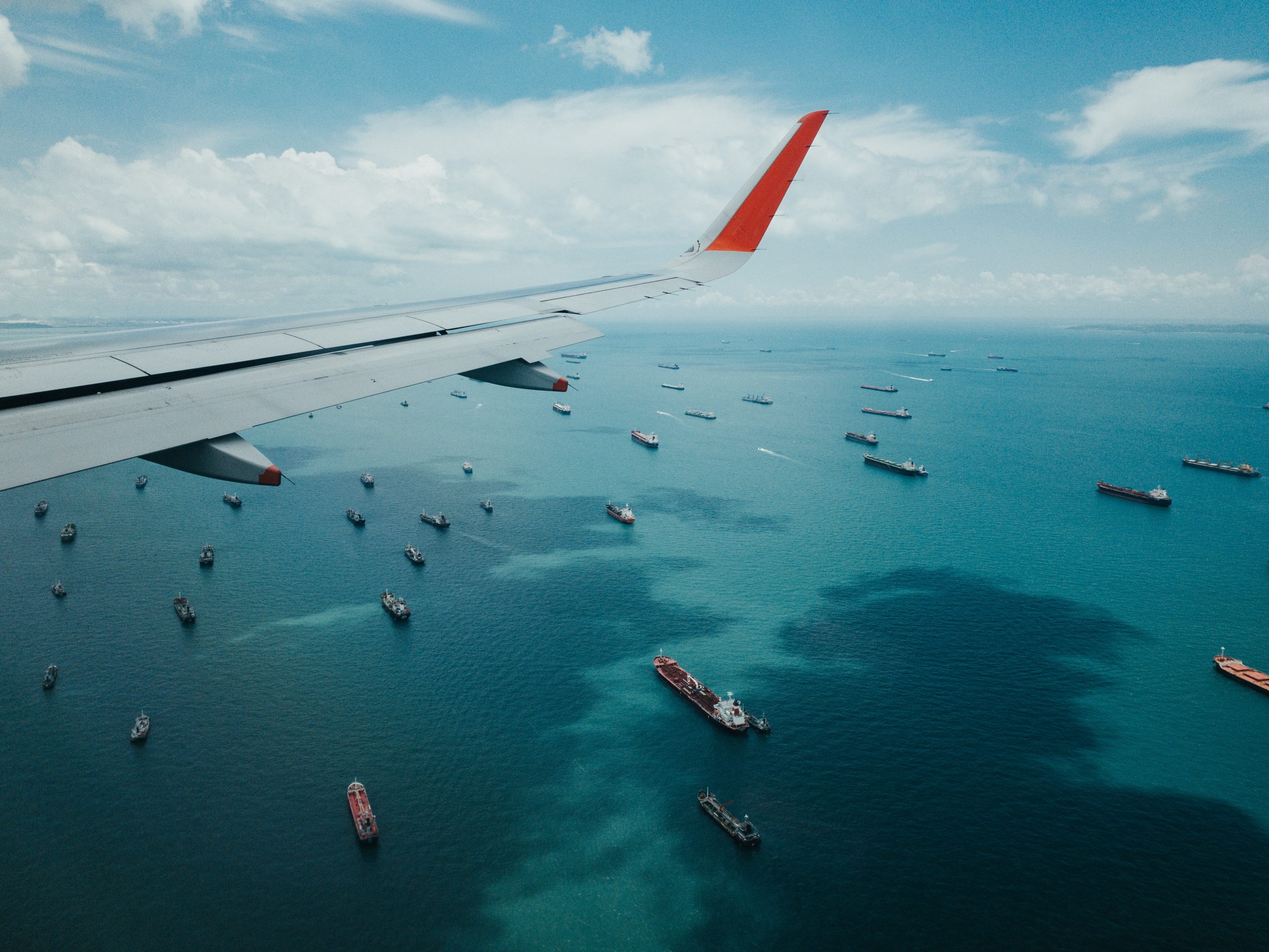 container ships waiting in line to get into the port